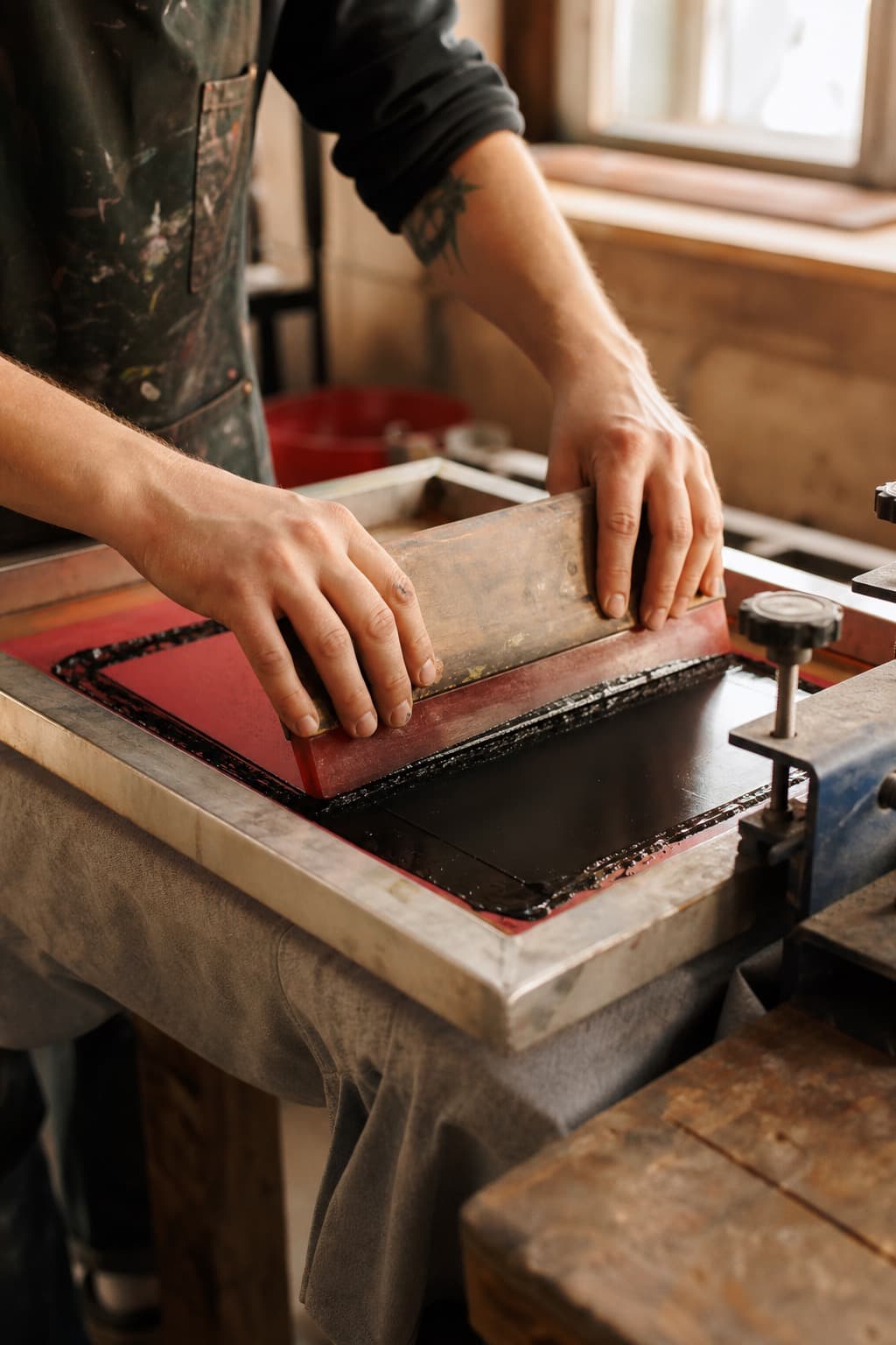 Screen-printing a tee in a Canadian workshop